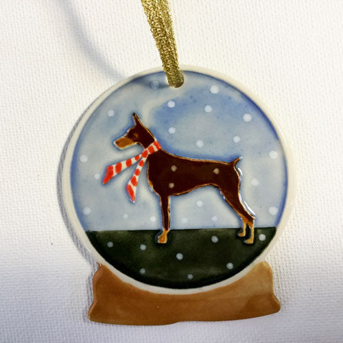 red doberman with red scarf on ornament