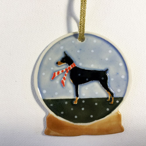 black dogie wearing red scarf holiday ornament